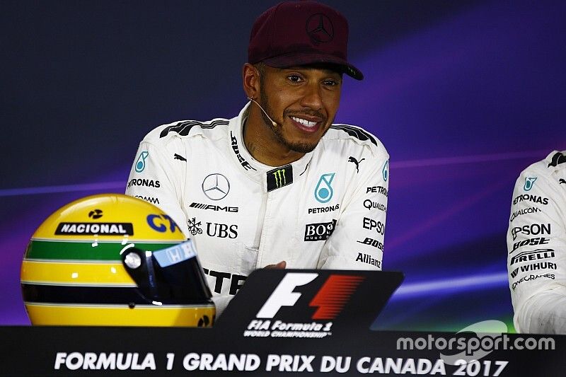 Lewis Hamilton, Mercedes AMG F1, shows off his Ayrton Senna helmet, a gift after equalling the Brazi