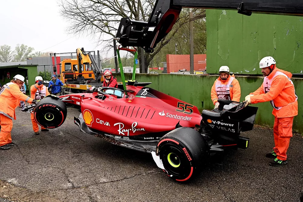 Marshals load the car of Carlos Sainz Jr., Ferrari F1-75, onto a truck