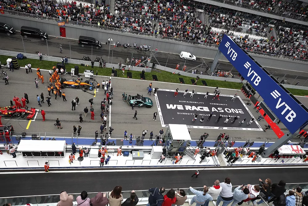 The drivers stand on the grid in support of the End Racism campaign prior to the start