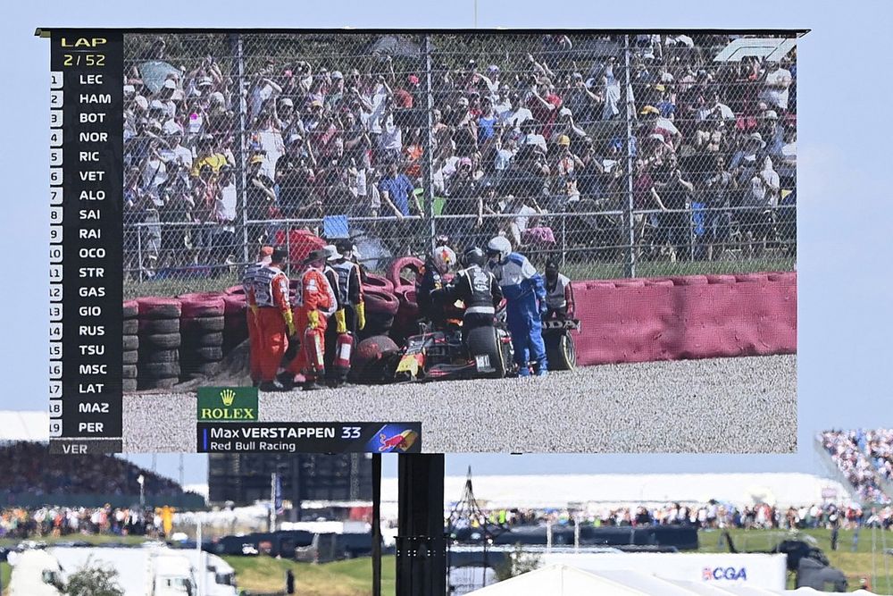 Max Verstappen, Red Bull Racing RB16B, climbs from his damaged car after crashing out on the opening lap