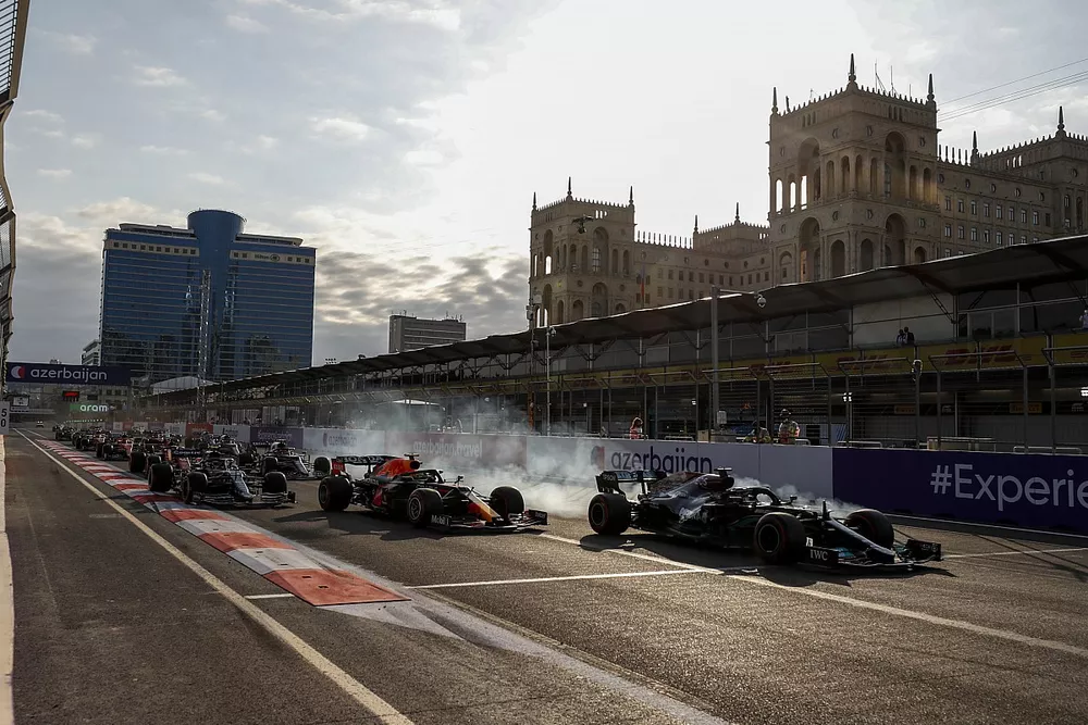 Lewis Hamilton, Mercedes W12 runs wide from Sergio Perez, Red Bull Racing RB16B at the restart of the race