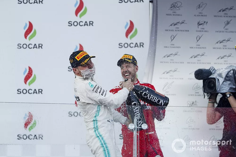 Valtteri Bottas, Mercedes AMG F1, 1st position, sprays the victory Champagne into his face and Sebastian Vettel, Ferrari, 3rd position, joins in