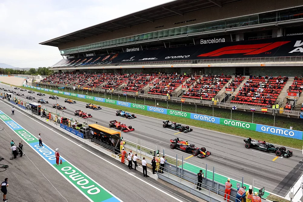 Lewis Hamilton, Mercedes W12, Max Verstappen, Red Bull Racing RB16B, and Valtteri Bottas, Mercedes W12, prepare to lead the field away for the start