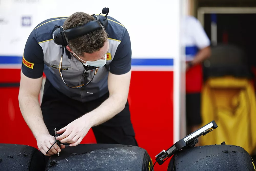 A Pirelli technician takes some data readings