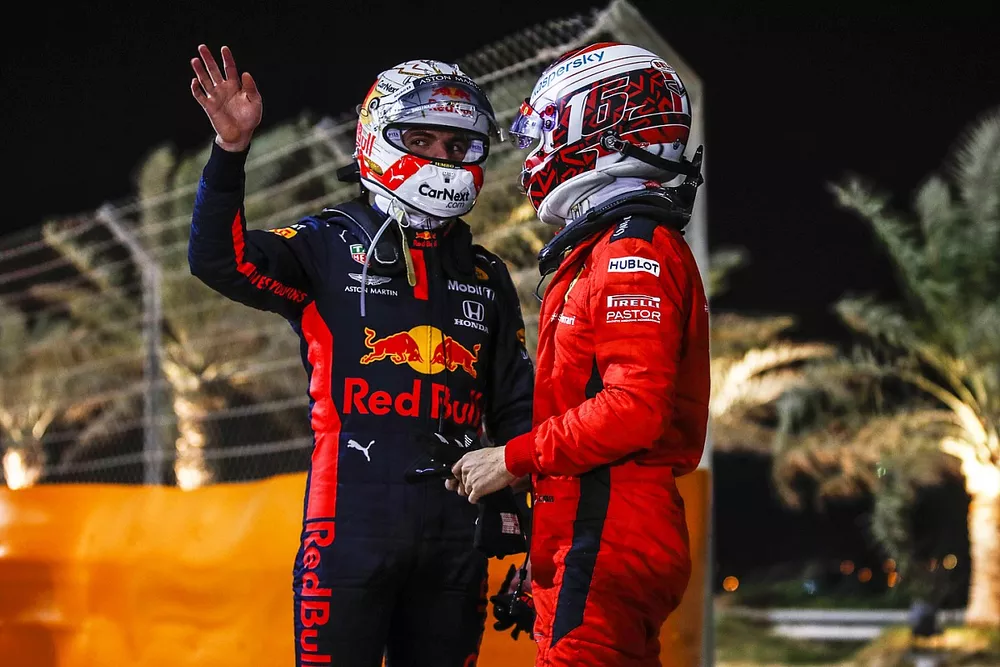 Max Verstappen, Red Bull Racing, and Charles Leclerc, Ferrari, chat after retiring