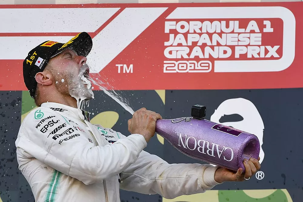 Sebastian Vettel, Ferrari, 2nd position, and Valtteri Bottas, Mercedes AMG F1, 1st position, celebrate on the podium with Champagne