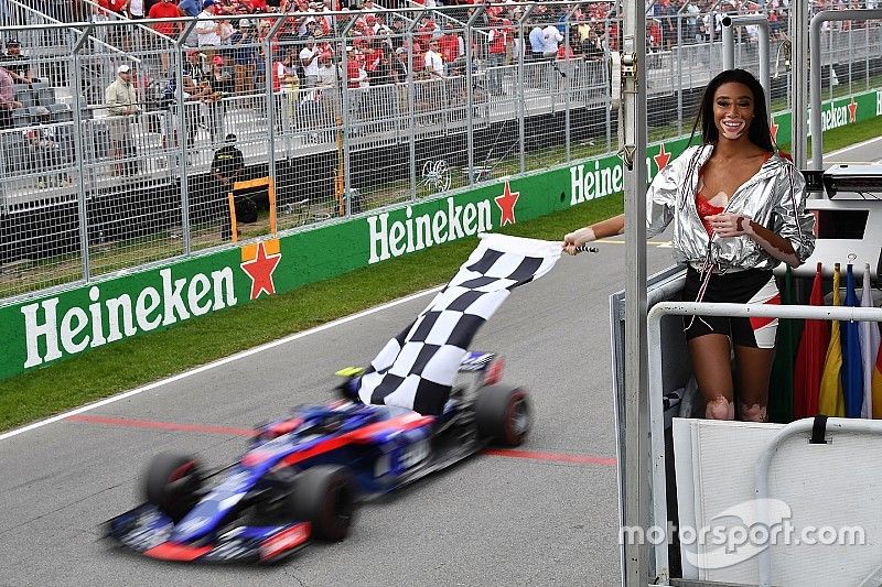 Winnnie Harlow, waves the chequered flag