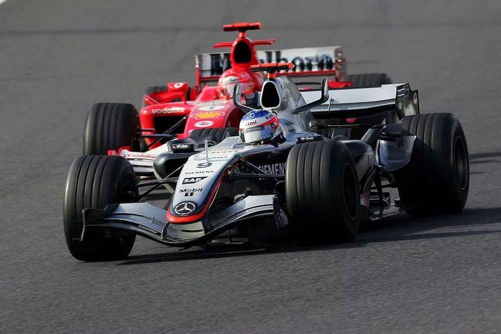 Kimi Raikkonen, McLaren Mercedes MP4/20 passes Michael Schumacher, Ferrari F2005