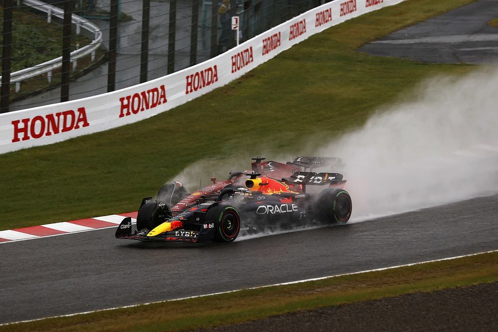 Max Verstappen, Red Bull Racing RB18, battles with Charles Leclerc, Ferrari F1-75, for the lead on the opening lap