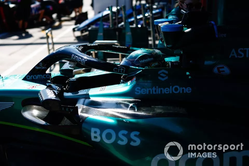 Lance Stroll, Aston Martin AMR24, is pushed back into the garage
