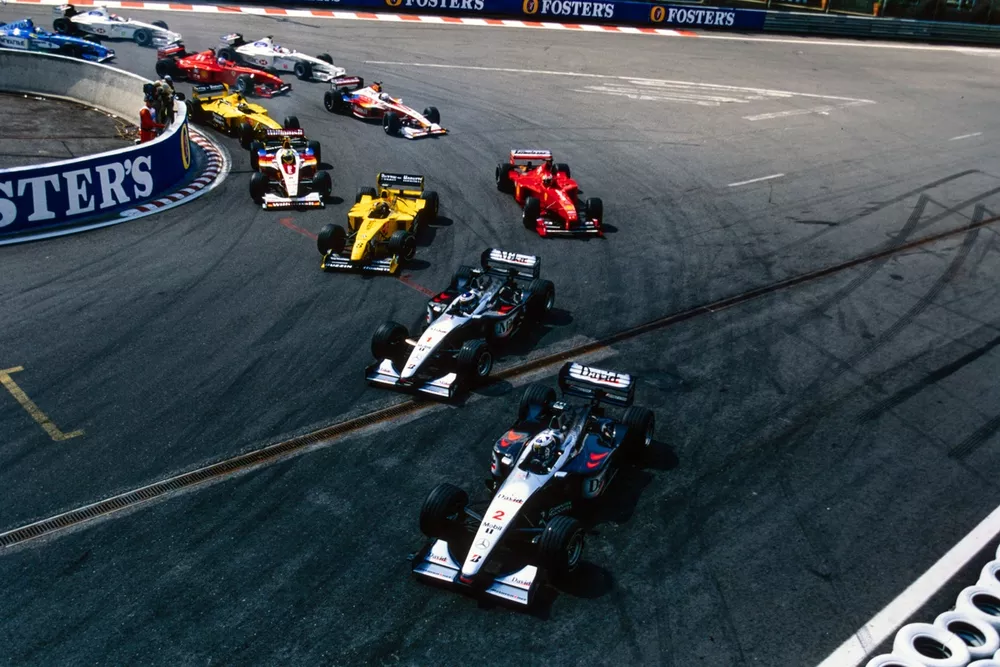 David Coulthard, McLaren MP4-14 Mercedes, leads Mika H&auml;kkinen, McLaren MP4-14 Mercedes, Heinz-Harald Frentzen, Jordan 199 Mugen-Honda, Eddie Irvine, Ferrari F399, and Ralf Schumacher, Williams FW21 Supertec, round La Source at the start.