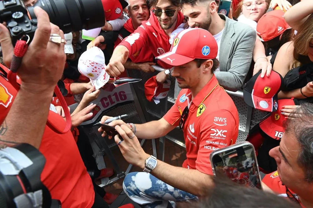 Charles Leclerc, Scuderia Ferrari, is mobbed by autograph hunters and fans
