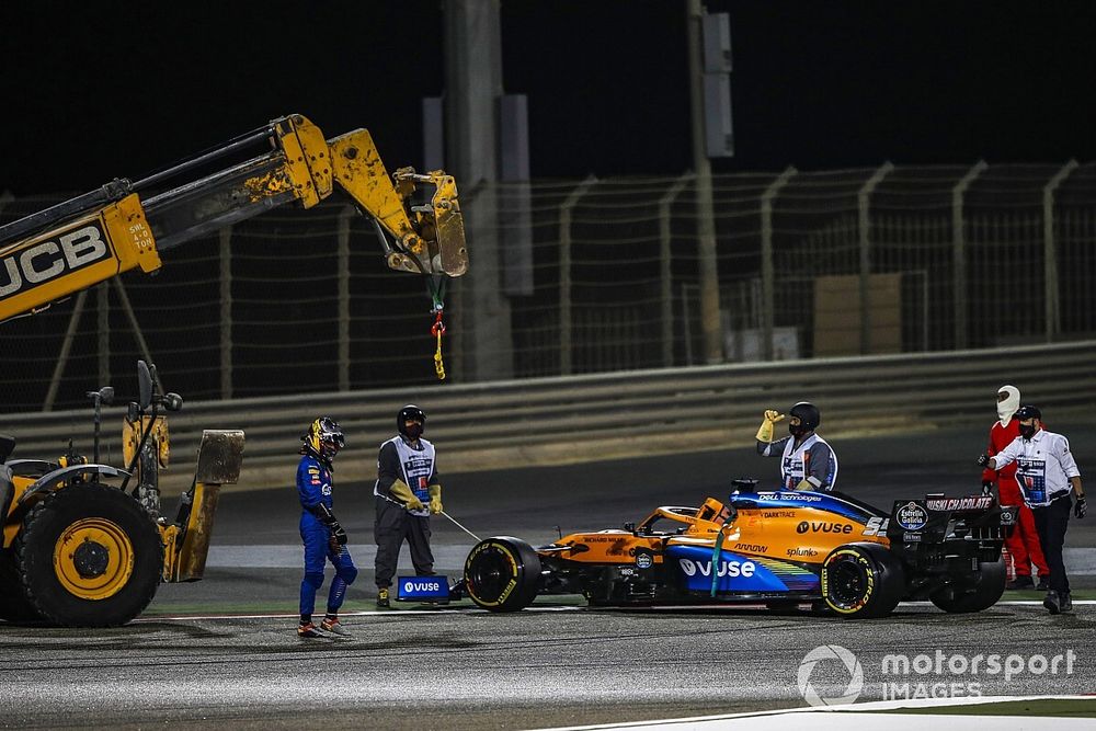 Marshals remove the car of Carlos Sainz Jr., McLaren MCL35, after he stopped with mechanical issues