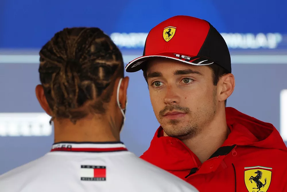 Charles Leclerc, Ferrari, speaks with Lewis Hamilton, Mercedes