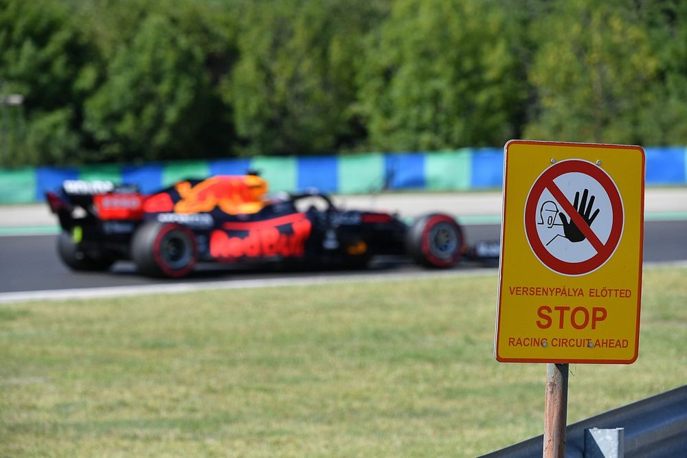 Max Verstappen, Red Bull Racing RB16B, passes a track side sign