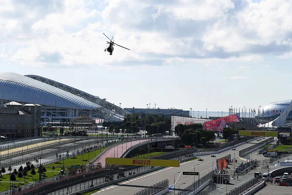 A Twin Squirrel Helicopter camera ship flies over the circuit