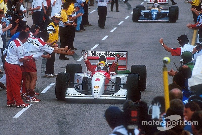 Ayrton Senna, McLaren celebrates 1st position on the way down the pit lane to parc ferme