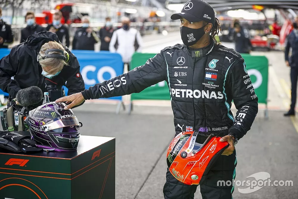 Lewis Hamilton, Mercedes-AMG Petronas F1, 1st position, on the podium with the helmet of Michael Schumacher