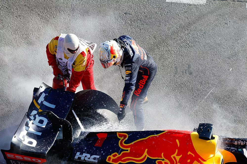 Max Verstappen, Red Bull Racing, retires from the race and a marshal assists with a fire