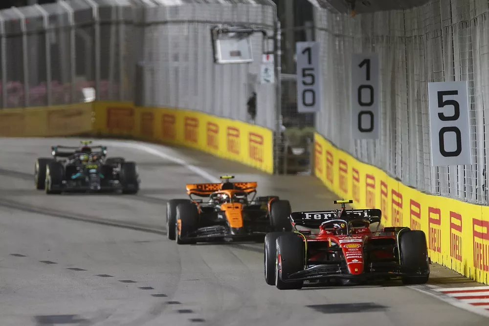 Carlos Sainz, Ferrari SF-23, leads Lando Norris, McLaren MCL60, and Sir Lewis Hamilton, Mercedes F1 W14