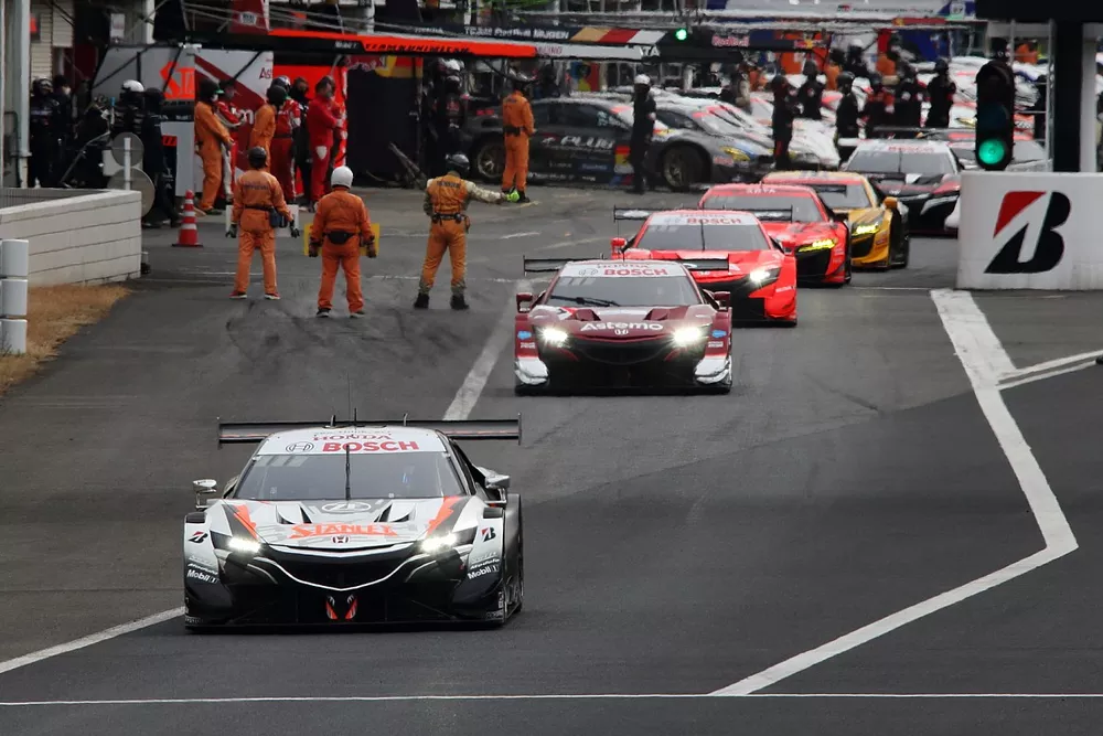 Cars leave the pitlane