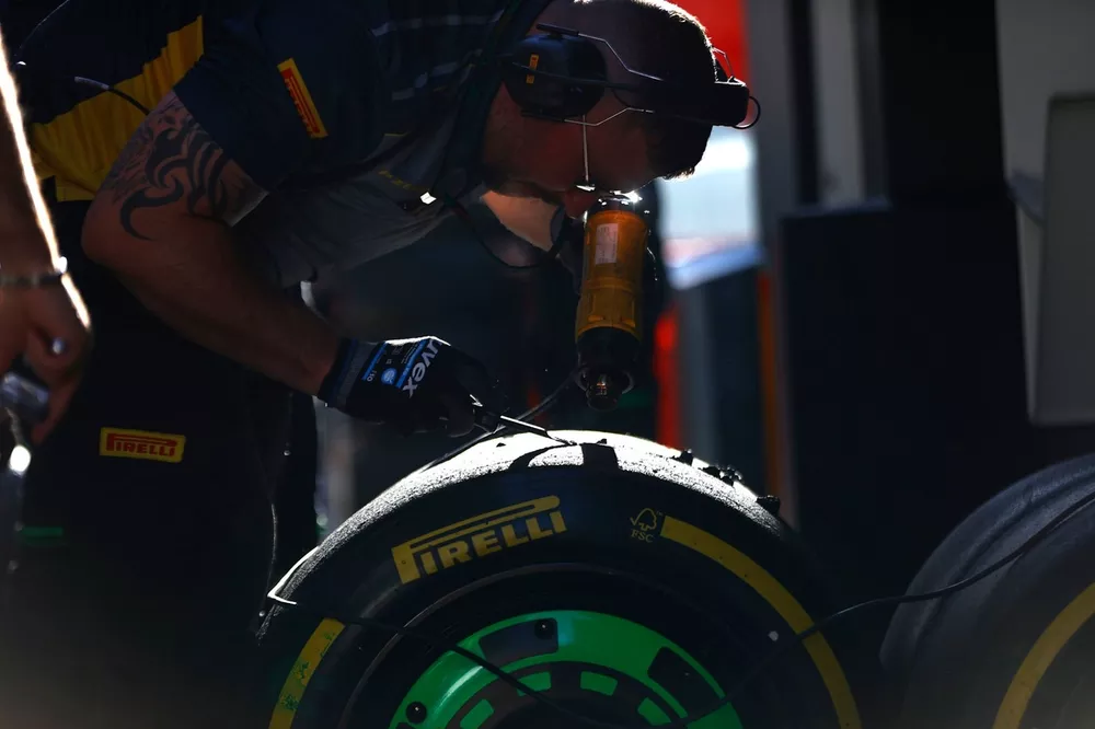 Een Pirelli-ingenieur schraapt een set banden die worden gebruikt door Stake F1 Team Kick Sauber 