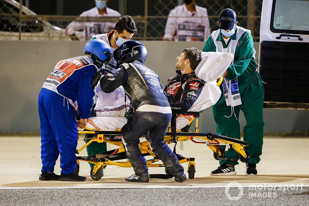 Medical delegates assist Romain Grosjean, Haas F1, after a huge crash on the opening lap