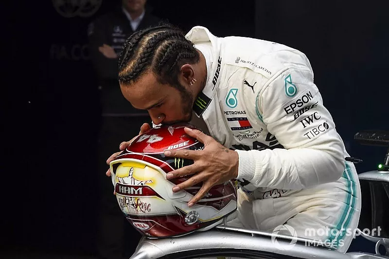 Lewis Hamilton, Mercedes AMG F1, 1st position, kisses his helmet in celebration in Parc Ferme