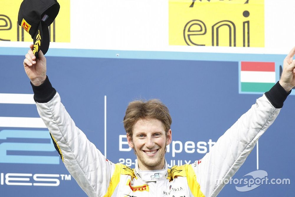 Romain Grosjean celebrates his victory on the podium