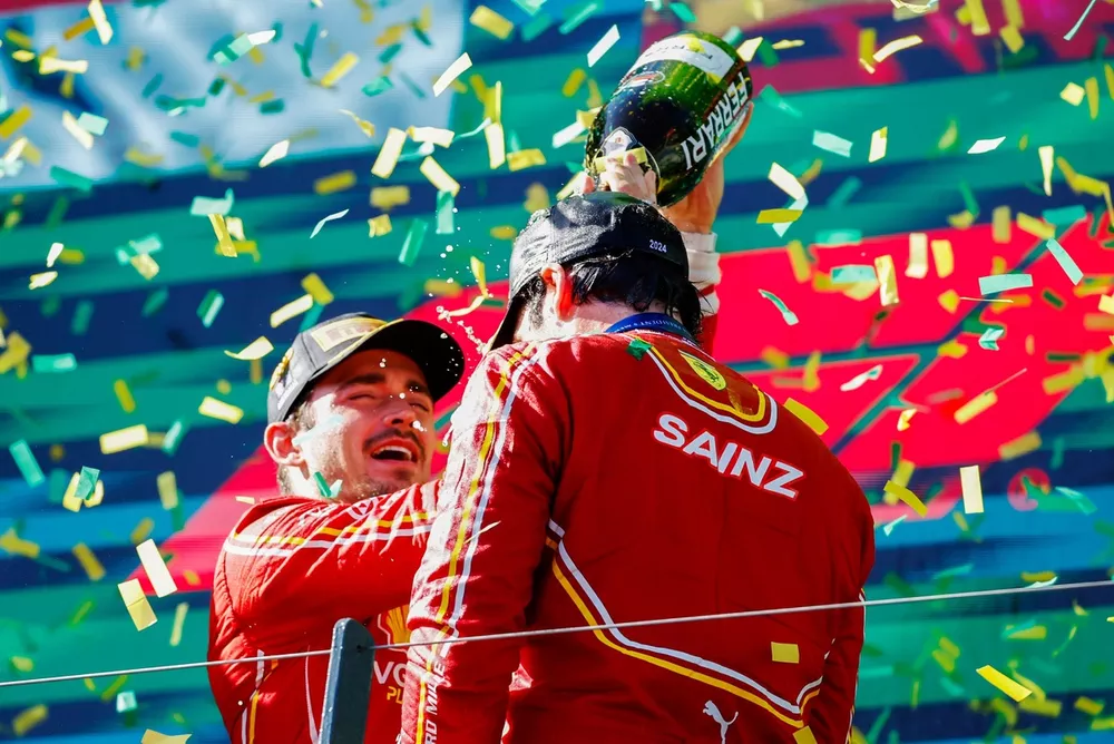 Charles Leclerc, Scuderia Ferrari, 2nd position, pours champagne over Carlos Sainz, Scuderia Ferrari, 1st position, on the podium in celebration