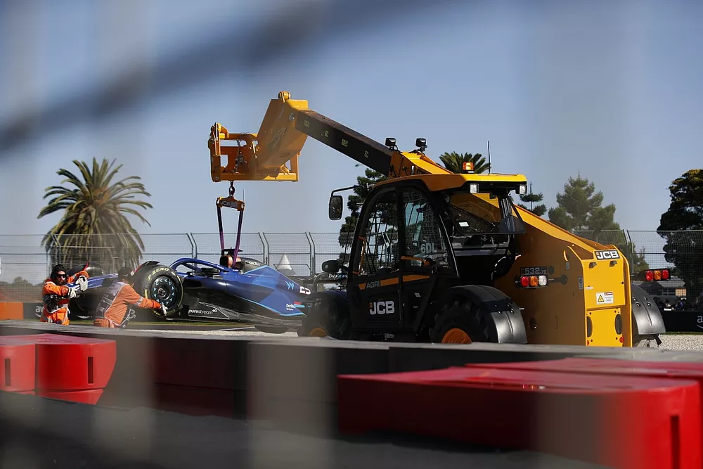 Marshals remove the damaged car of Alex Albon, Williams FW45, from the circuit