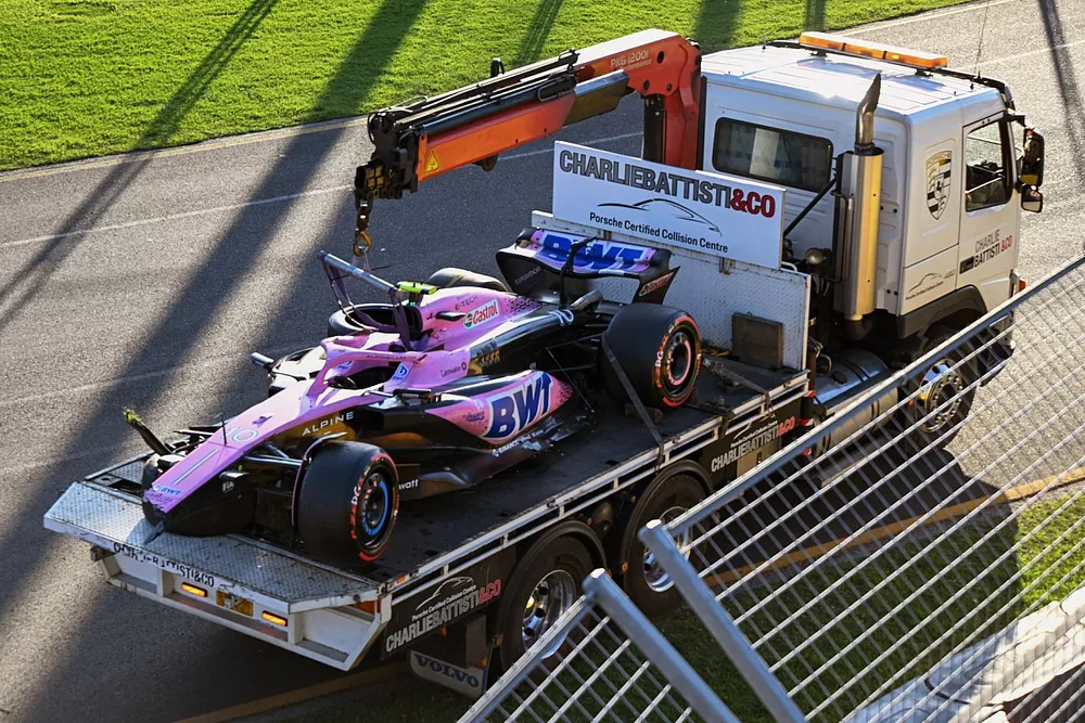 Marshals remove the damaged car of Pierre Gasly, Alpine A523, with a truck after the race