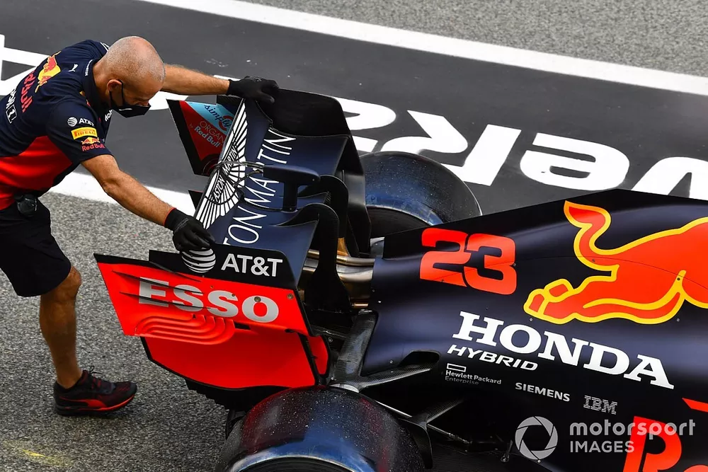 Mechanics push the Alexander Albon Red Bull Racing RB16 in the pit lane