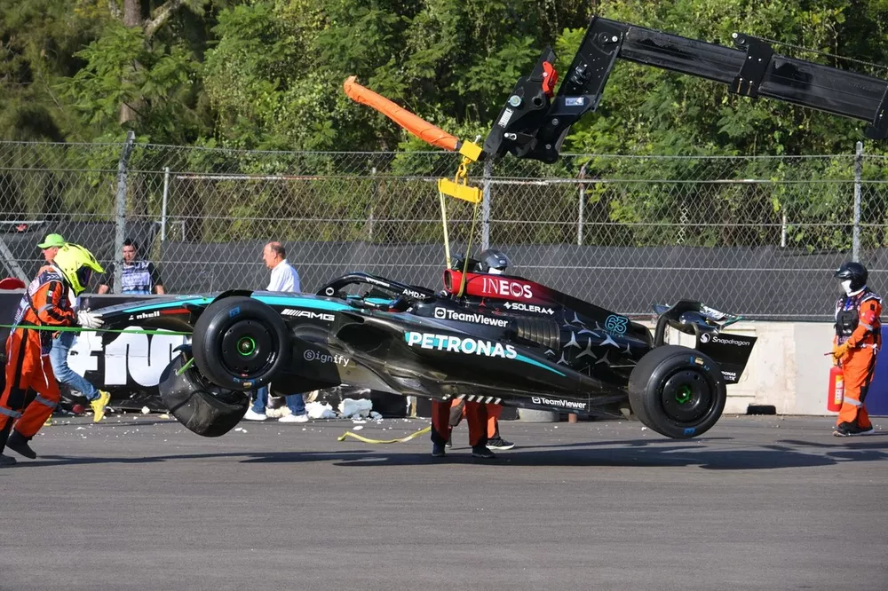 Marshals remove the damaged car of George Russell, Mercedes F1 W15, from the circuit after a crash in FP2