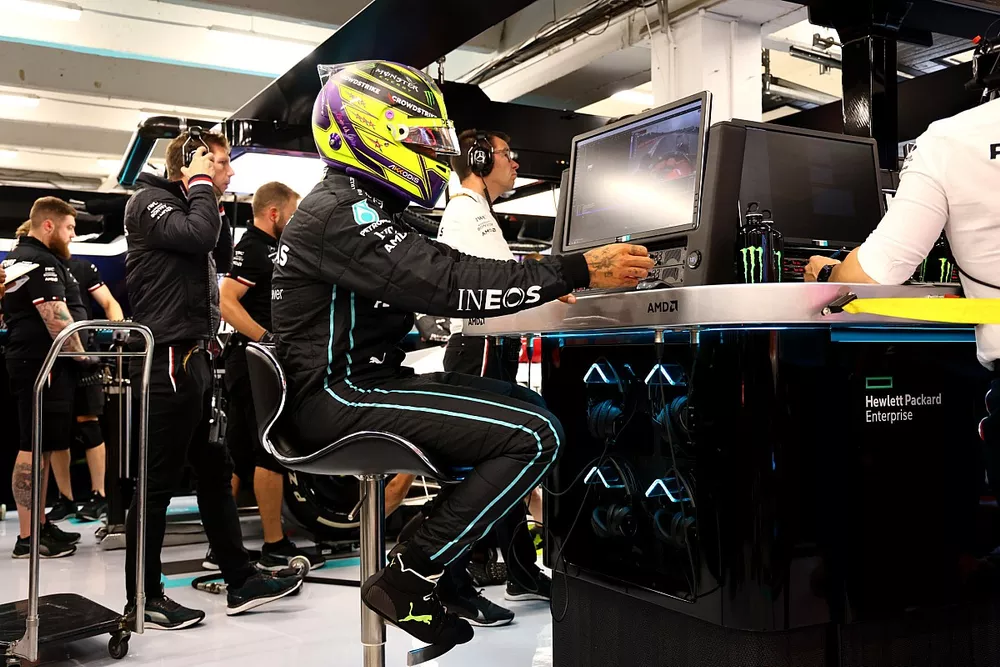 Lewis Hamilton, Mercedes-AMG, studies data in the team's garage