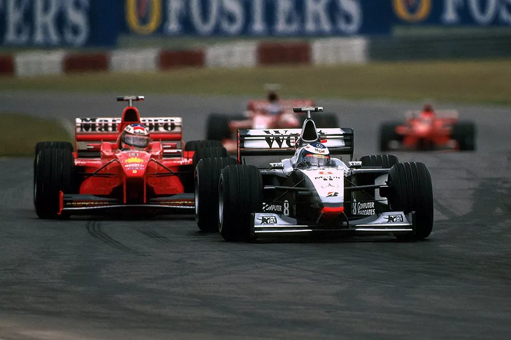 Mika Hakkinen, McLaren Mercedes MP4/13 leads Michael Schumacher, Ferrari F300