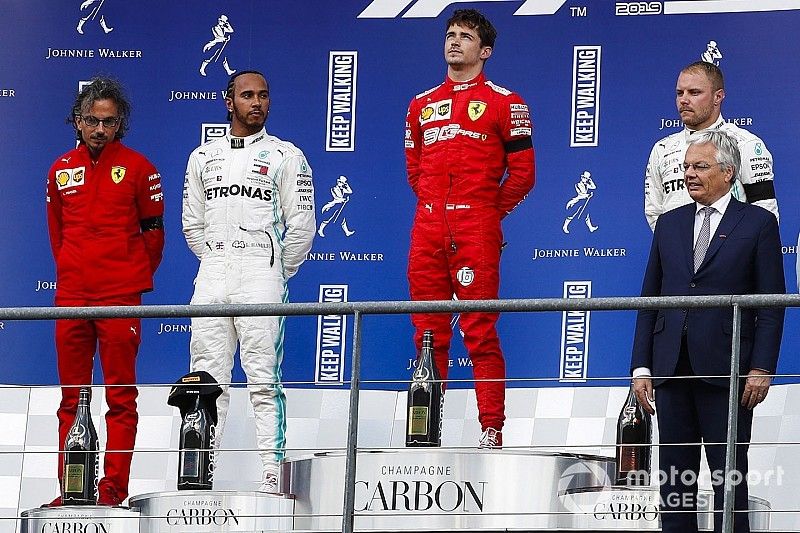 Charles Leclerc, Ferrari, celebrates on the podium with Lewis Hamilton, Mercedes AMG F1 and Valtteri Bottas, Mercedes AMG F1