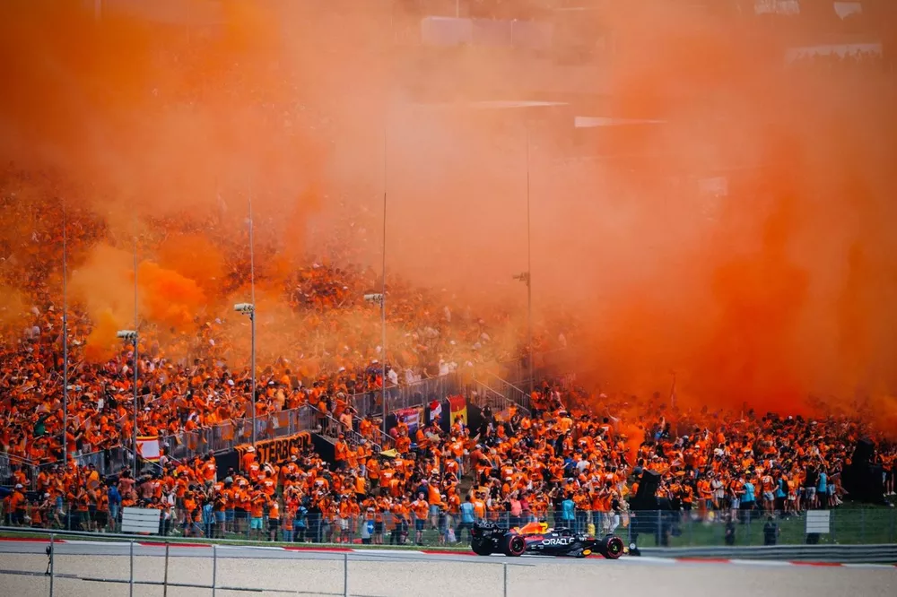Max Verstappen, Red Bull Racing RB19 with fans, orange smoke