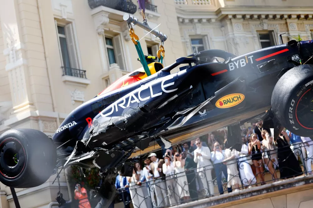 Marshals remove the car of Sergio Perez, Red Bull Racing RB20, from the circuit after an opening lap crash