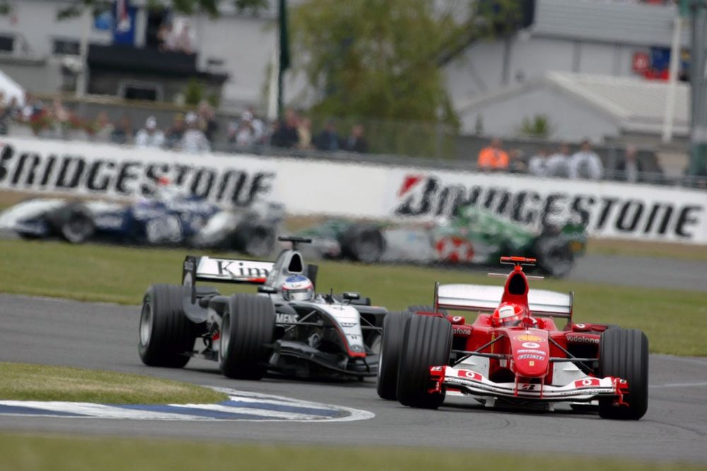 Michael Schumacher, Ferrari F2004, leads Kimi Raikkonen, McLaren Mercedes MP4/19B