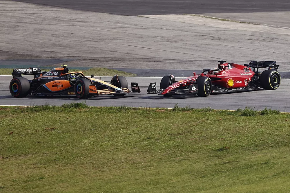 Lando Norris, McLaren MCL36, Charles Leclerc, Ferrari F1-75, collide, resulting in a spin