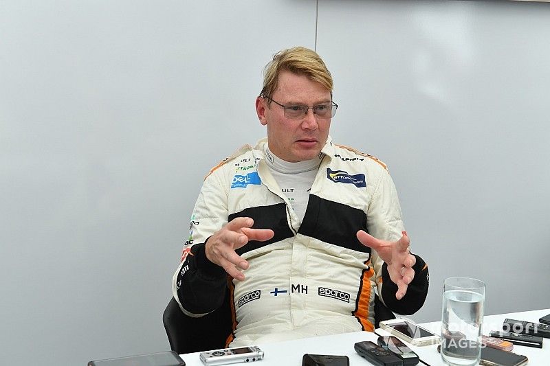 Mika Hakkinen talks with the media at Legends F1 30th Anniversary Lap Demonstration