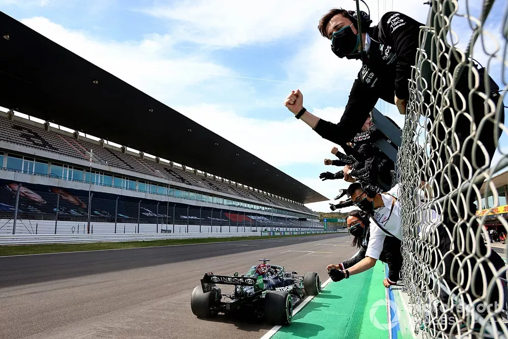Lewis Hamilton, Mercedes W12, 1st position, takes victory to the delight of his team on the pit wall