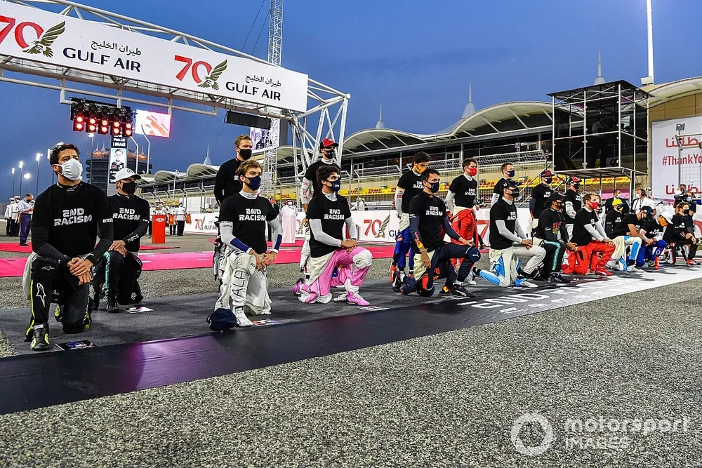 The drivers gather on the grid for a minutes' silence in support of ending racism.
