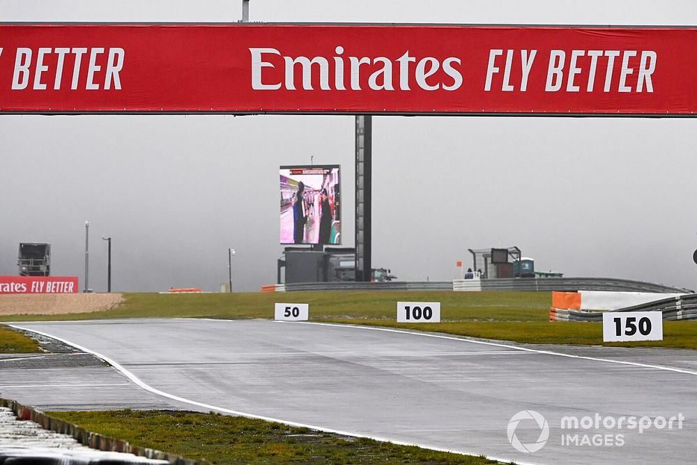 A track side screen in use as rain lashes the circuit