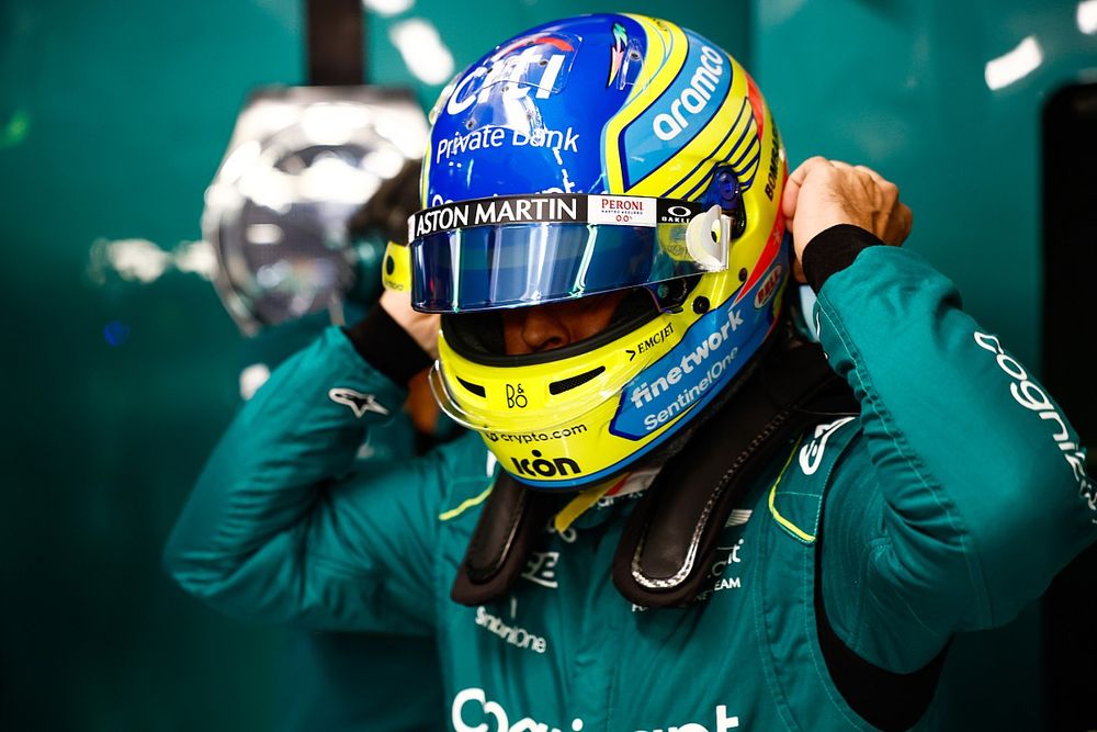 Fernando Alonso, Aston Martin F1 Team, puts on his crash helmet