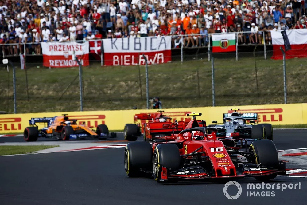 Charles Leclerc, Ferrari SF90, leads Valtteri Bottas, Mercedes AMG W10, Sebastian Vettel, Ferrari SF90, and Carlos Sainz Jr., McLaren MCL34