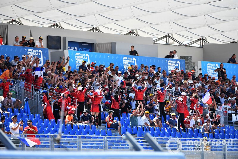 A French Grand Prix promotion squad among fans in a grandstand