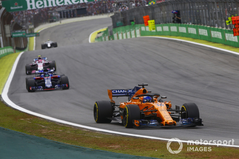 Fernando Alonso, McLaren MCL33, leads Brendon Hartley, Toro Rosso STR13, and Esteban Ocon, Racing Point Force India VJM11