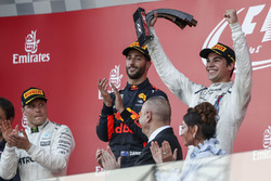 Lance Stroll, Williams celebrates on the podium, the trophy alongside race winner Daniel Ricciardo, Red Bull Racing and Valtteri Bottas, Mercedes AMG F1